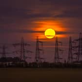 The Hunter's Moon rises above the electricity pylons at the National Grid Substation, west of Monk Fryston.