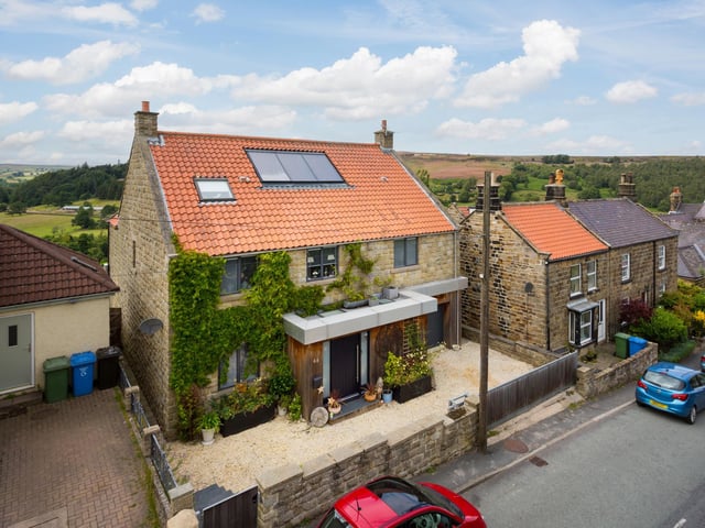 The village home has electric gates fronting the driveway, and an integral garage.