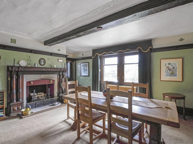An imposing fireplace is the focal point of this spacious dining room.