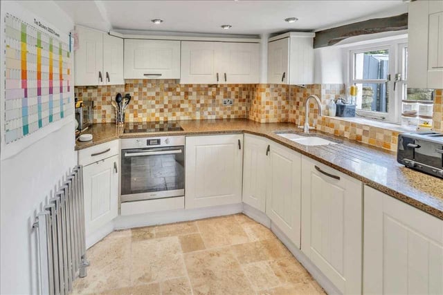 Modern Shaker style kitchen with Granite worktops, Induction Hob and Large Single Oven. Built in appliances include fridge, freezer and dishwasher.