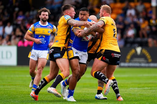 Castleford Tigers' Alex Mellor, left and Joe Westerman tackle Sam Lisone of Leeds Rhinos. Picture by Olly Hassell/SWpix.com.