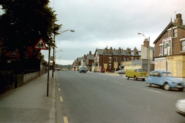 July 1981 and in focus is Roundhay Road looking north-east during a time of riots in the area. All the shop fronts are boarded up for protection including that of Halina Travel Burueau on the right. Further along, a garage situated between Lascelles Street and Back Lascelles Terrace is also boarded up.