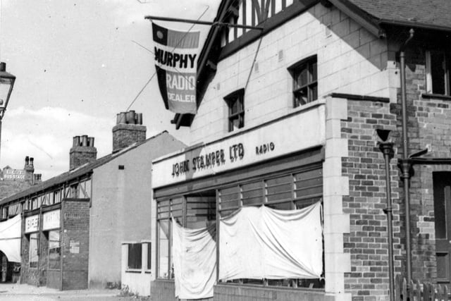 J. Stamper Ltd. radio dealer on Station Road pictured in August 1947. Above the shop is a flag pole with flag advertising Murphy radios. The shop windows are draped with sheets.