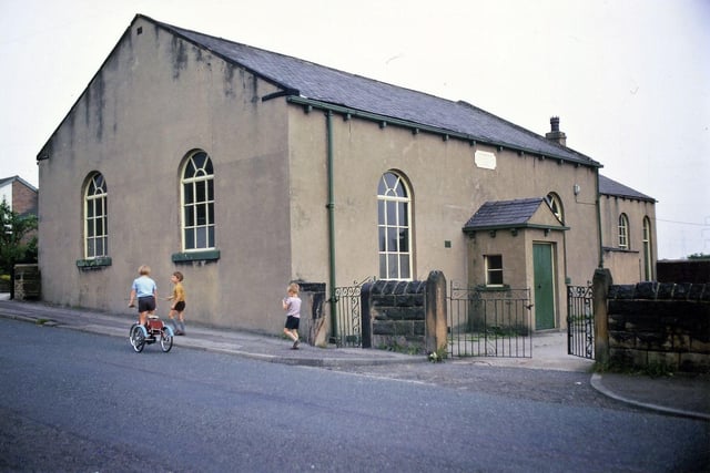 The Ebenezer Primitive Methodist Chapel in Haigh Moor Road in July 1971. There is a plaque on the wall above the porch. Three small boys can be seen in Haigh Moor Road, one riding a tricycle.