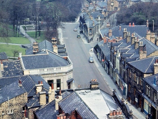 Looking north along Queen Street from the tower of Morley Town Hall which includes a substantial part of the town. The roof at the very bottom of the picture is that of Lloyd's Bank which is still standing. All the other roofs on this side of the road as far as the park have been cleared away and replaced by the Queen's Court complex of flats and shops. These include the glass roof of the Fent Warehouse Arcade, the higher building surrounding it, the old Post Office and telephone exchange, the Yorkshire Bank and an older block beyond which contained the gas showrooms during the Second World War. Pictured in April 1965.