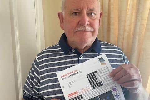 Frank Moane, 73, pictured with the fine he received for stopping at Leeds Bradford Airport.