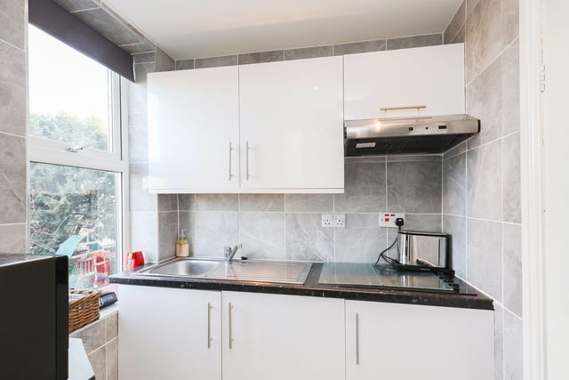 The house offers accommodation across four floors including this kitchen.