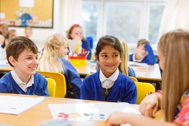 Teacher with two pupils in the classroom
