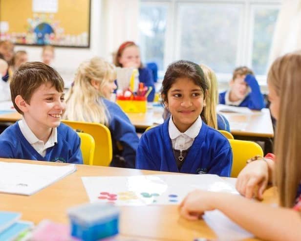 Teacher with two pupils in the classroom