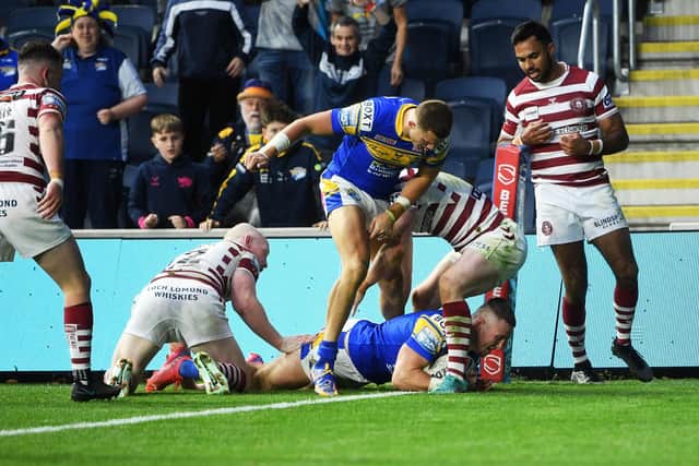 Harry Newman, pictured scoring fior Rhinos against Wigan, will undergo scans on a hamstring inury. Picture by Jonathan Gawthorpe.