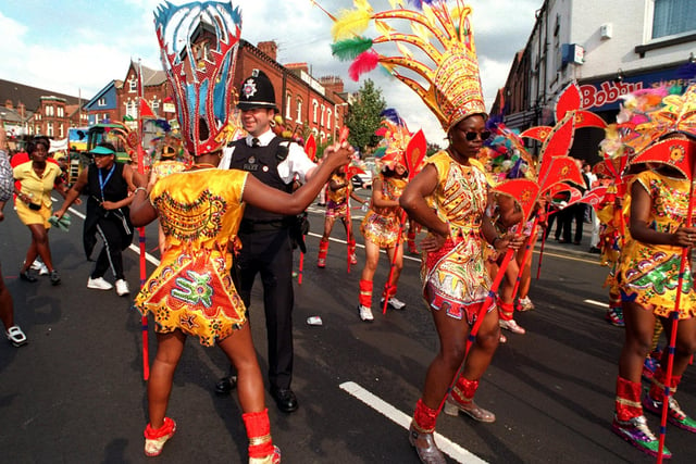 On the Beat. Community constable PC Joe Scott joins in the dancing as the Leeds West Indian Carnival parade makes its way down Roundhay Road.