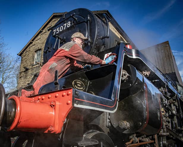 Volunteer Barrie Woodward polishes up an engine early in the morning in the yard in Haworth for the first day of the annual Steam Gala weekend on the Keighley and Worth Valley Railway. Photograph by Tony Johnson