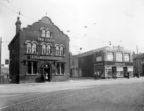 The Woodpecker pub at the junction of Burmantofts Street and York Road pictured in Septemebr 1935. The Woodpecker was no. 1 York Road, selling Ind Coope Beer, its landlord at the time was J. Hegarty. It was built in the early 19th Century and bought by Leeds Council in 1938 for £6,000. It closed in 1939 and a new Woodpecker Inn was built and opened on the opposite corner. On 15th March 1941 the old pub was severely damaged by bombing as was Maurice Adlemans' clothing store at nos. 3-5, seen here on the right advertising a summer sale; both were subsequently demolished. A new Adleman's store was built opposite next to the new Woodpecker.