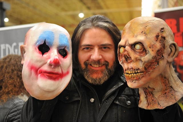 Steve Wilson with some of the latex horror masks sold on his stall.