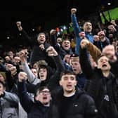 Leeds fans cheer and sing ahead of the English Premier League football match between Leeds United and Manchester City at Elland Road (Photo by OLI SCARFF/AFP via Getty Images)