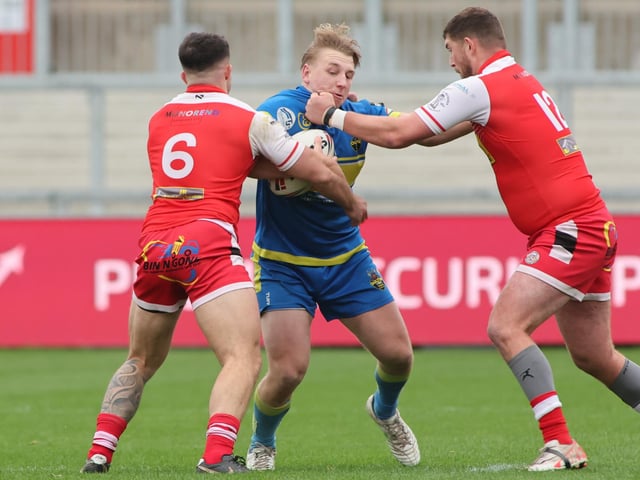 Ben Brady, of Oulton Raiders, is halted by East Leeds' Dave Gibbons and Ryan Wooffitt during the National League Division One play-off final at Wakefield Trinity's Belle Vue.