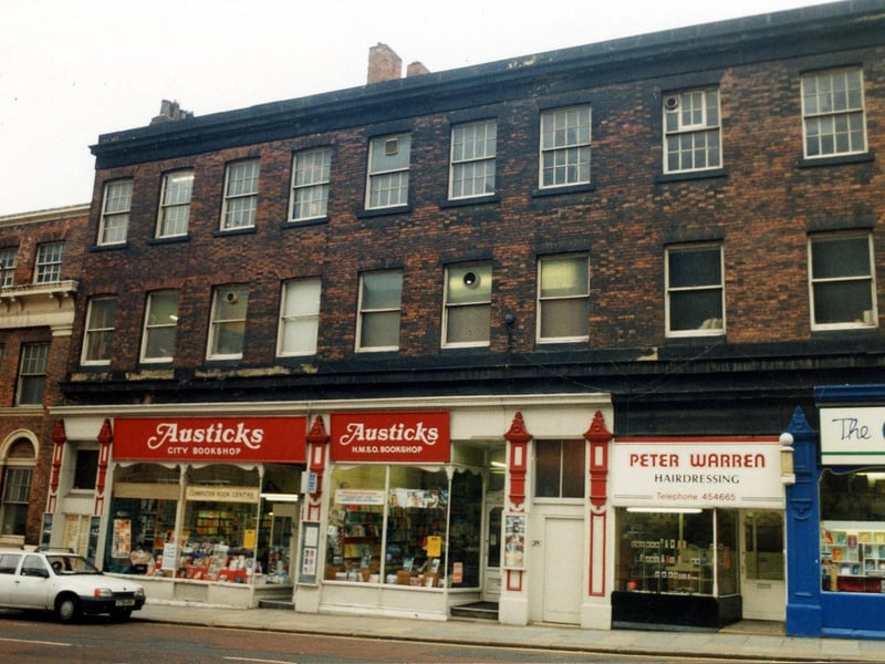 Cookridge Street in April 1990. Shops in focus are, on the left, Austicks H.M.S.O. bookshop then Peter Warren hairdressers. On the far right is the Carmel Religious Bookshop. In 1992 this building was redeveloped and opened as shops, offices and a bar.