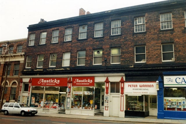 Cookridge Street in April 1990. Shops in focus are, on the left, Austicks H.M.S.O. bookshop then Peter Warren hairdressers. On the far right is the Carmel Religious Bookshop. In 1992 this building was redeveloped and opened as shops, offices and a bar.