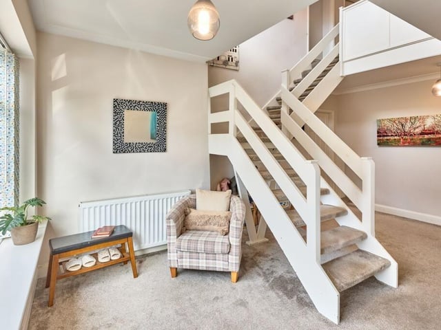 The reception hallway features an open turned staircase, and is flooded with natural light thanks to the double height ceiling and front aspect windows.