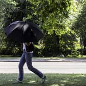 Someone walking through the park with an umbrella. (Pic credit: Brook Mitchell / AFP via Getty Images)