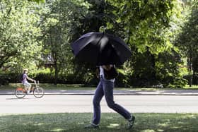 Someone walking through the park with an umbrella. (Pic credit: Brook Mitchell / AFP via Getty Images)