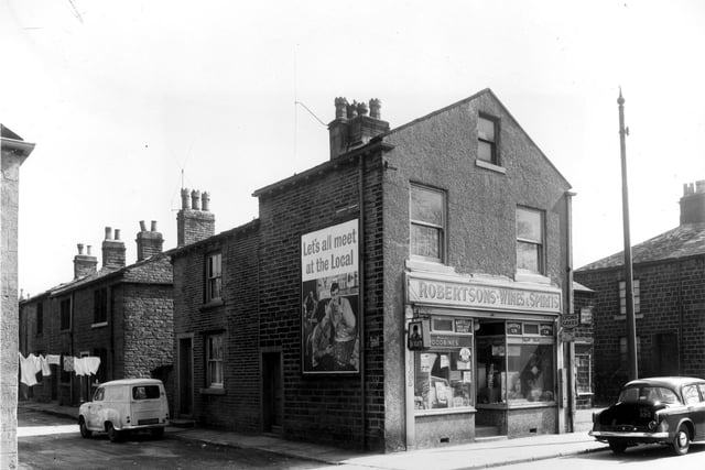 A view of stone-built terraced dwellings looking from the junction with Upper Town Street. They are situated in Hanover Street and number in descending order from the left in the direction of Town street, 10 to 2. Number 2 is part of the premises of off-license, Roberton's wines and spirits at 368 Upper Town Street. Pictured in April 1960.