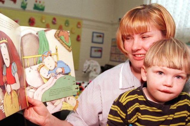 Tyler Burnip enjoying a story being told by his mother Elizabeth in 1999.