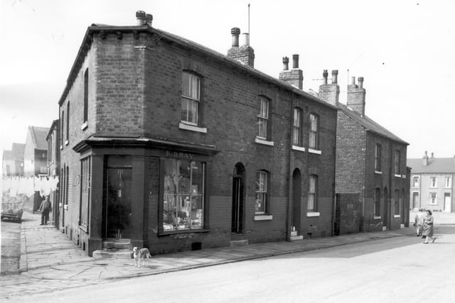 Milner Grove is on the left, the shop at the corner is number 7 Anchor Road. It is drapers shop, the business of John Bray. Joseph Street can be seen on the far right. Pictured in April 1964.