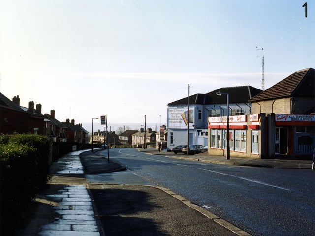 Osmondthorpe Lane, showing A.J.R. Superstores, general grocer and off licence, on the right. Beyond this is Timmerdales ice cream factory with an advertising hoarding on the wall.