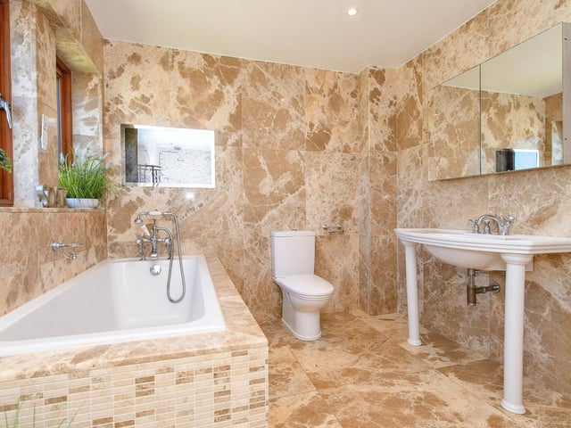 A stunning, fully tiled bathroom