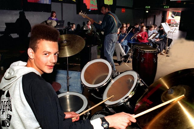 Young volunteer musicians gathered at the Students Union Building at Leeds Metropolitan University to rehearse for Breeze '97', Leeds City Council's first week-long youth festival of gigs, sport, drama, dance and dabate. Pictured is drummer Kevin Bellwood, 15, keeps time as the band is led by conductor Andrew Macgill, centre.