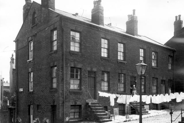 Brick built terraced houses on Dinsdale Terrace which had been designated for clearance. These houses are back to back and have steep steps up to the entrances.