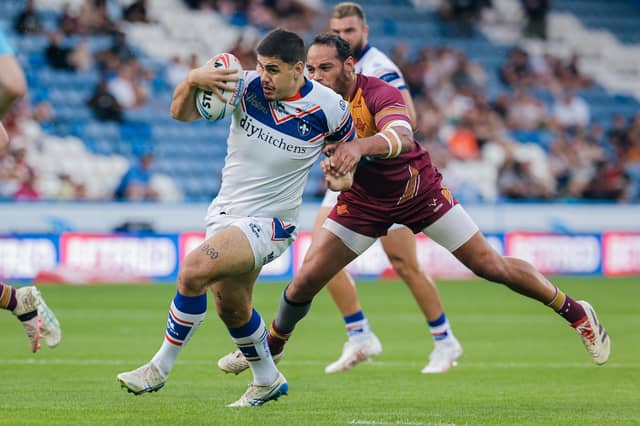 Caleb Hamlin-Uele is tackled by Leroy Cudjoe during Wakefield Trinity's win at Huddersfield Ginats last week. Picture by Alex Whitehead/SWpix.com.