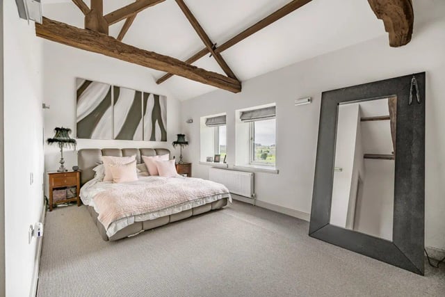 To the first floor is a spacious mezzanine landing area that leads you to the luxurious master bedroom with a vaulted ceiling with exposed wooden beams. There are a further three bedrooms.