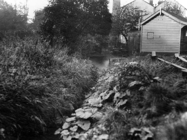 Footbridge across beck. The footpath leads from Meanwood Road, up past Yorkshire Switchgear, to Woodhouse Ridge. A wooden hut is to the right of the photo. Pictured in October 1936.