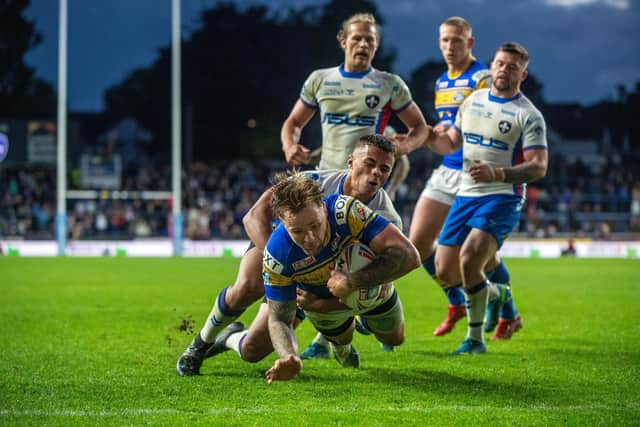 James Donaldson scores for Rhinos in last May's home win over Wakefield, who return to Headingley in round four. Picture by Bruce Rollinson.