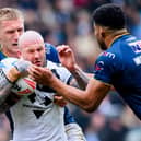 Zak Hardaker is tackled by Mikolaj Oledzki during Hull FC's win against Leeds Rhinos in March. Picture by Allan McKenzie/SWpix.com.