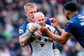 Zak Hardaker is tackled by Mikolaj Oledzki during Hull FC's win against Leeds Rhinos in March. Picture by Allan McKenzie/SWpix.com.