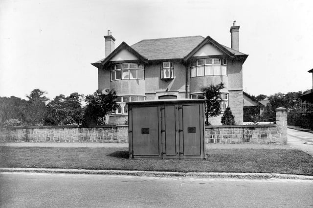 A detached house, electricity kiosk on grass verge in June 1936.