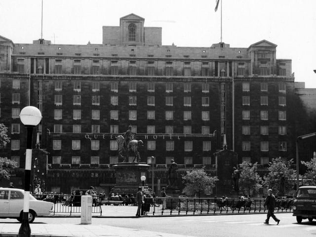 The Queens Hotel in June 1967. People are sitting on benches in City Square.