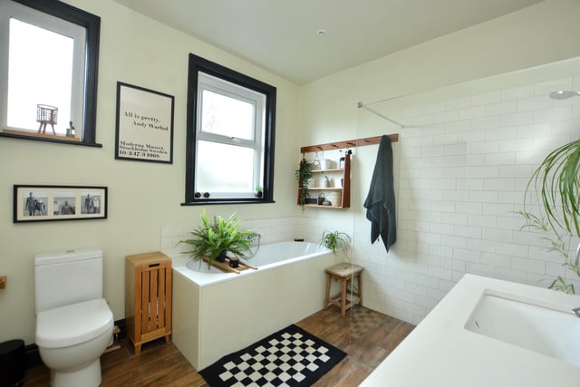 The house bathroom has underfloor heating and is fitted with a modern four piece suite in white including a walk-in shower.