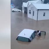 Woman is pulled from car during heroic flood rescue