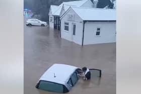 Woman is pulled from car during heroic flood rescue
