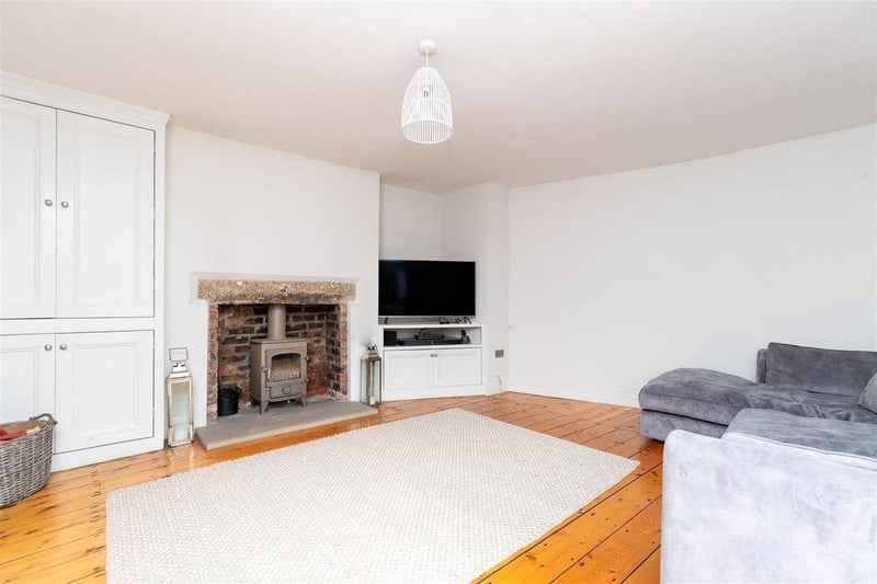 A large room with a feature fireplace and exposed brickwork around the log burner is sure to wow your guests. It includes a recessed area for a TV, with original wooden floors which have been lovingly restored.
