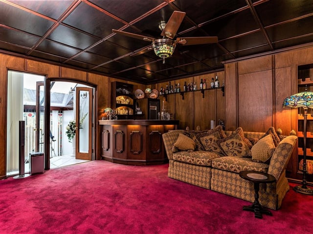 A comfortable lounge with bespoke, built-in bar.