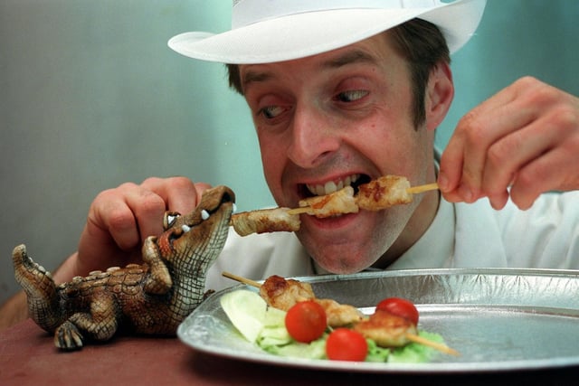 John Green of Wilsons Butcher bites into the shop's new barbeque special in May 1998 -  a crocodile kebab.