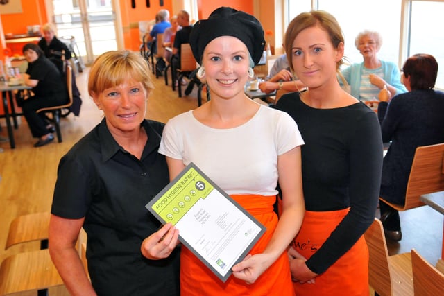 Eugene's staff  member Beth Wilkinson holds the Food Hygiene certificate as fellow staff members Margaret (left) and Andrea Downes look on in 2013.