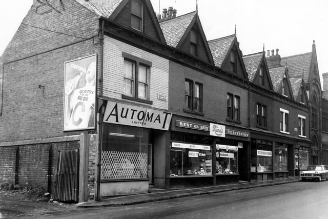 The Amberley Buildings, a row of commercial properties on Tong Road which went through to residential buildings on Florence Street. They feature the Automat Ltd, to the right and Rhinds, television contractors and dealers. There is also a hairdressers, business of Albert H. Meechan. Pictured in May 1965.