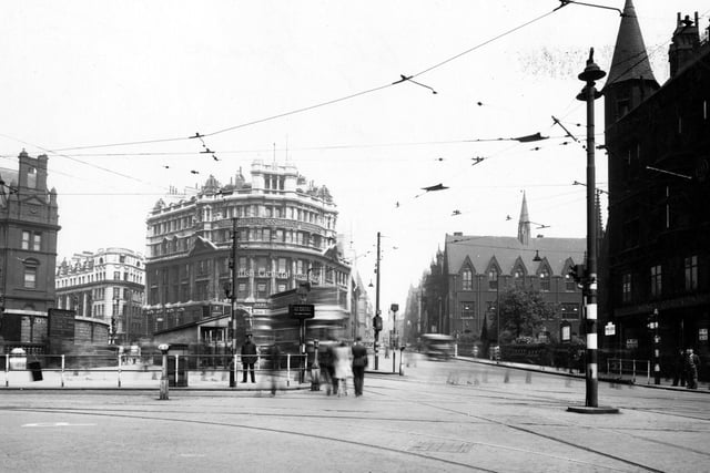 City Square shows the Standard Life Assurance buildings on the corner of Park Row and Boar Lane in July 1942. Offices for British General Insurance and Norwich Union are inside. A statue and part of the General Post Office are visible on the left.