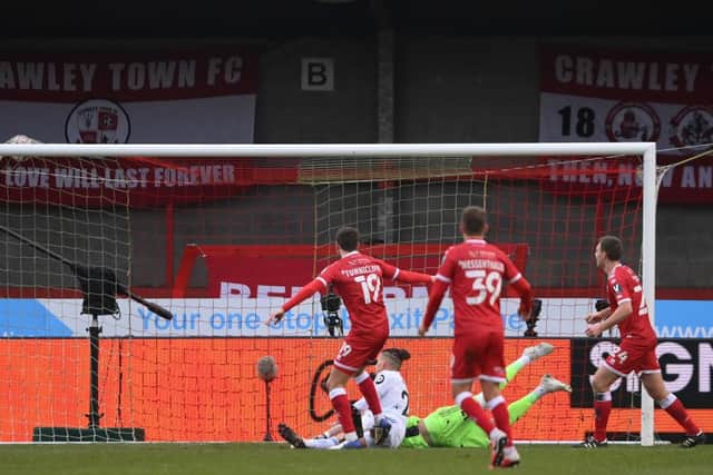 Jordan Tunnicliffe scores Crawley Town's third goal past Kiko Casilla after a set-piece.